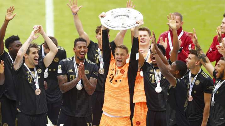 Bayern's goalkeeper Manuel Neuer holds the trophy after winning the Bundesliga title