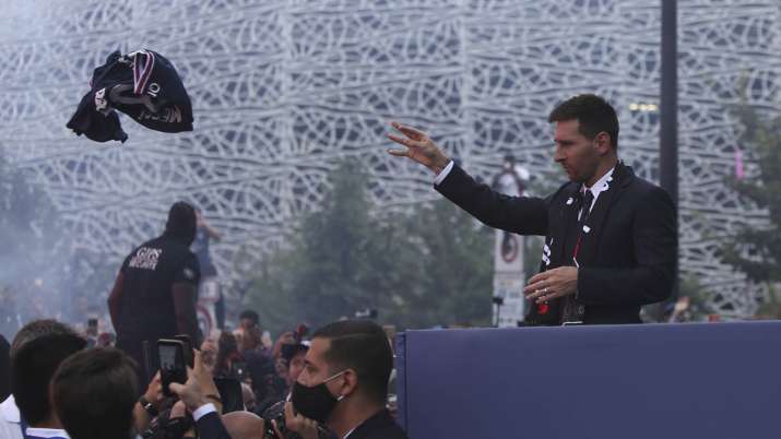 Lionel Messi throws a team jersey to Paris Saint-Germain