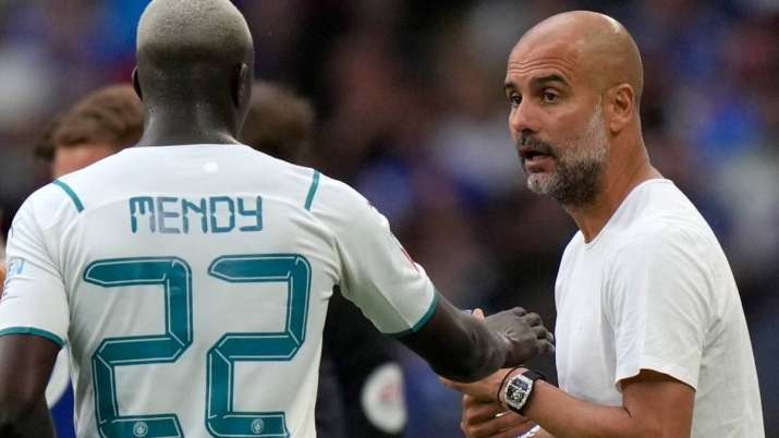 Manchester City's head coach Pep Guardiola gives instructions to Benjamin Mendy