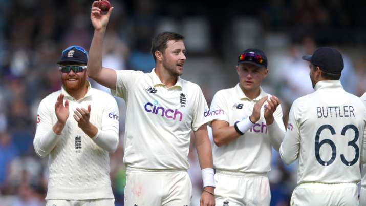 England bowler Ollie Robinson holds aloft the ball after