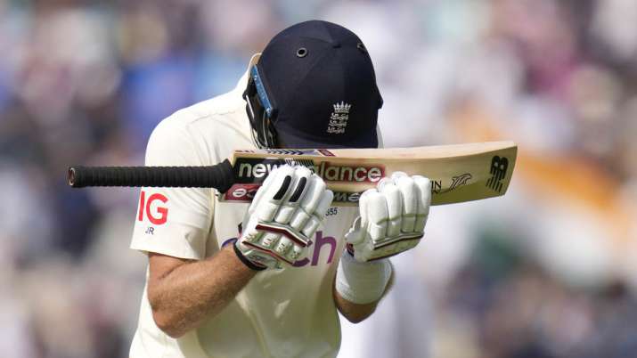 England's Joe Root puts his head on his bat as he leaves