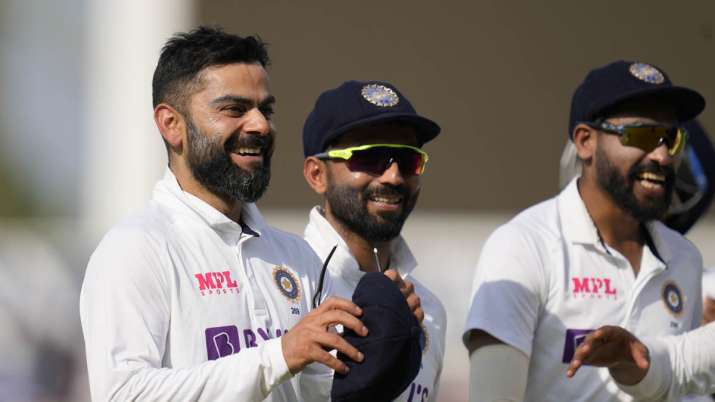India's captain Virat Kohli smiles as he leaves the pitch