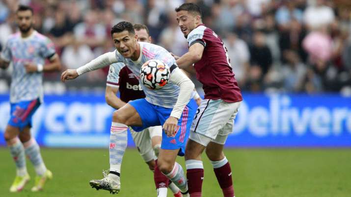 Manchester United's Cristiano Ronaldo, left, went for