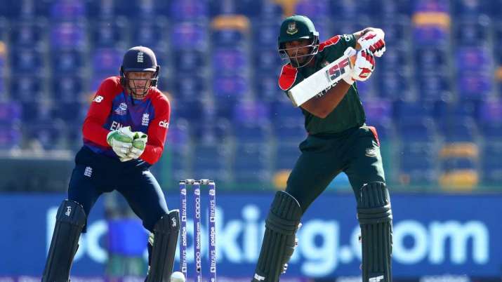 Mahmudullah of Bangladesh plays a shot as Jos Buttler of England looks on during the ICC Men's T20 W