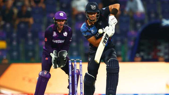 JJ Smit of Namibia plays a shot as Matthew Cross of Scotland looks on during the ICC Men's T20 Worl