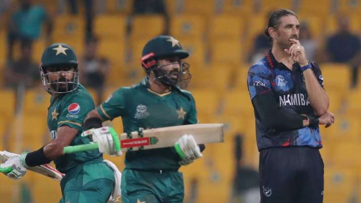 Pakistan captain Babar Azam and Mohammad Rizwan run between the wickets as Namibia's David Wiese clocks in
