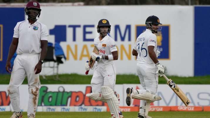 Sri Lankan batters Pathum Nissanka (centre) and Dimuth Karunaratne run between wickets as West Indie