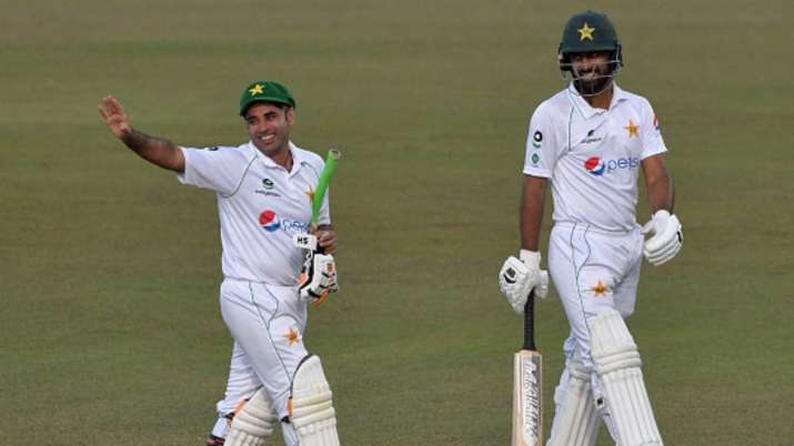 Pakistan's Abid Ali (left) and teammate Abdullah Shafique walk back to the pavilion at the end of th
