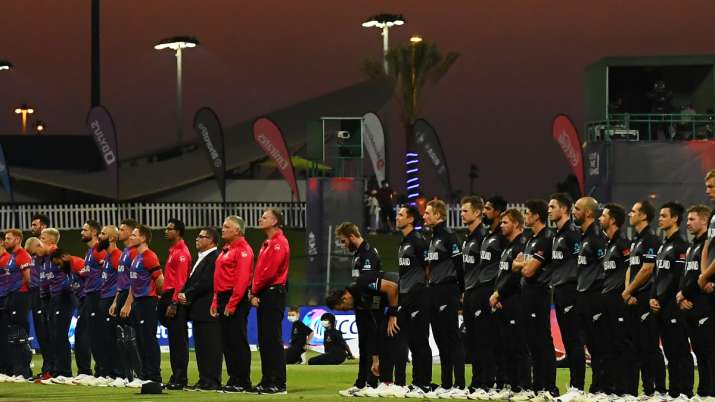Players of England and New Zealand take part in a minute silence in memory for Head Groundsmen Mohan
