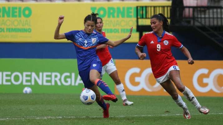 India defender Ngangbam Sweety Devi (in blue) vies for the ball with Chile's forward Maria Jose Urru