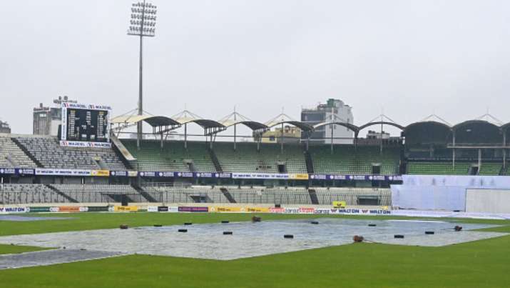The pitch is covered with plastic sheets as rain interrupts the start of the third day of the second